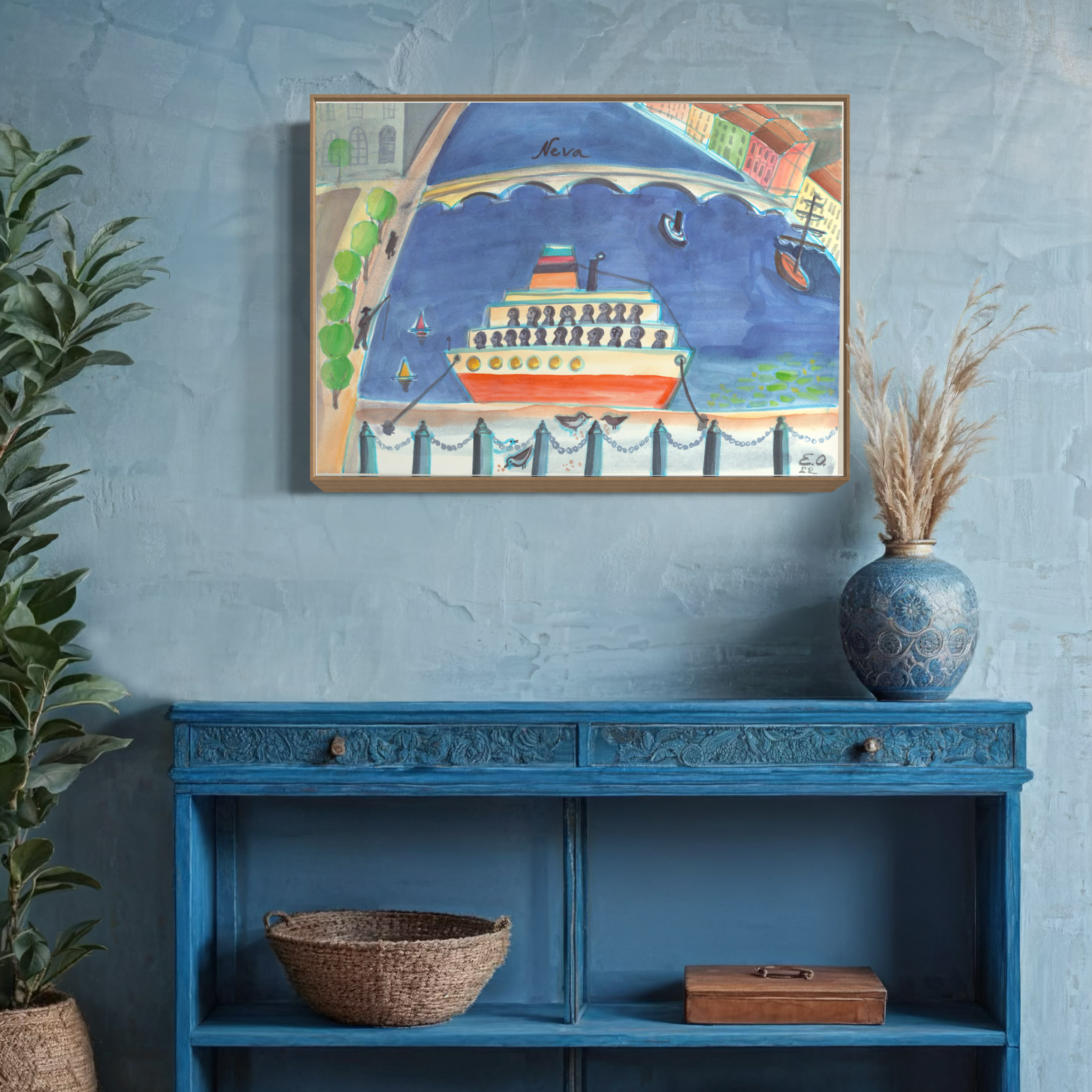 Blue console table with decorative items against a blue wall with a framed painting.