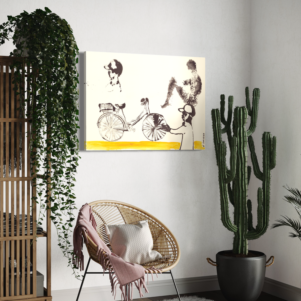 Room interior with a chair, cactus plant, and wall art of two people on a bicycle.