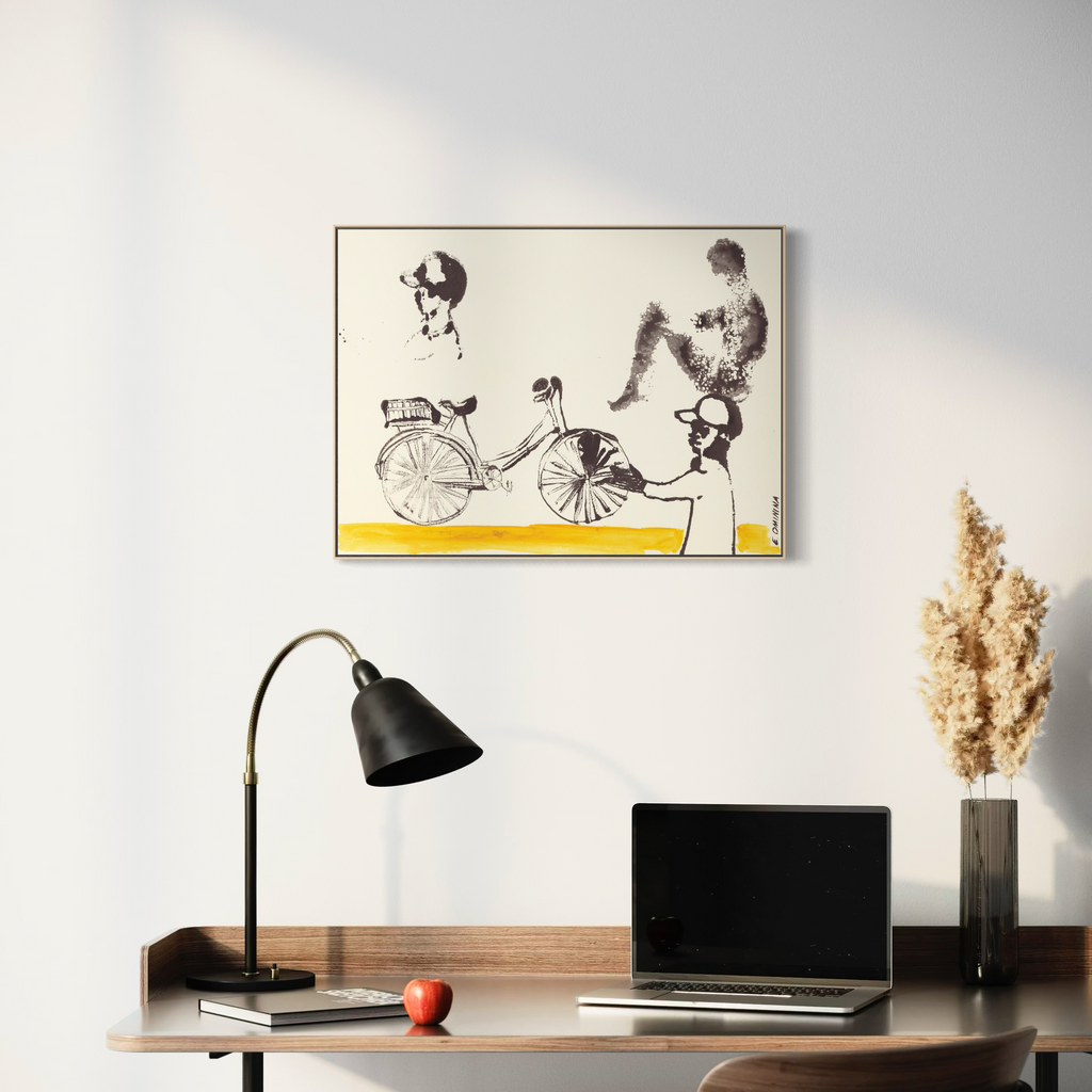 Modern office setup with a framed bicycle Art Print on the wall, desk, lamp, and laptop.